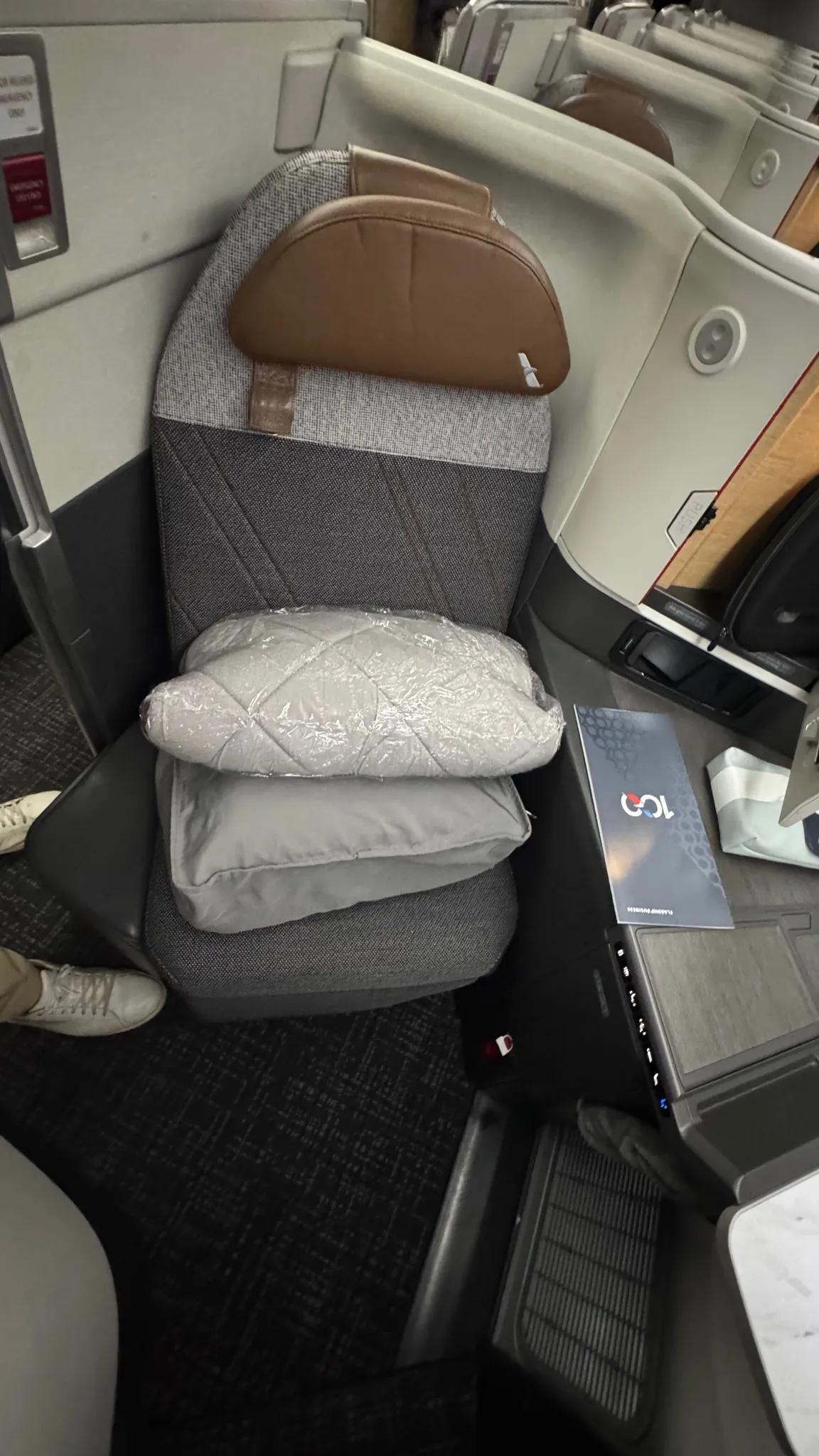 Pillows and bedding waiting at my seat before departure.