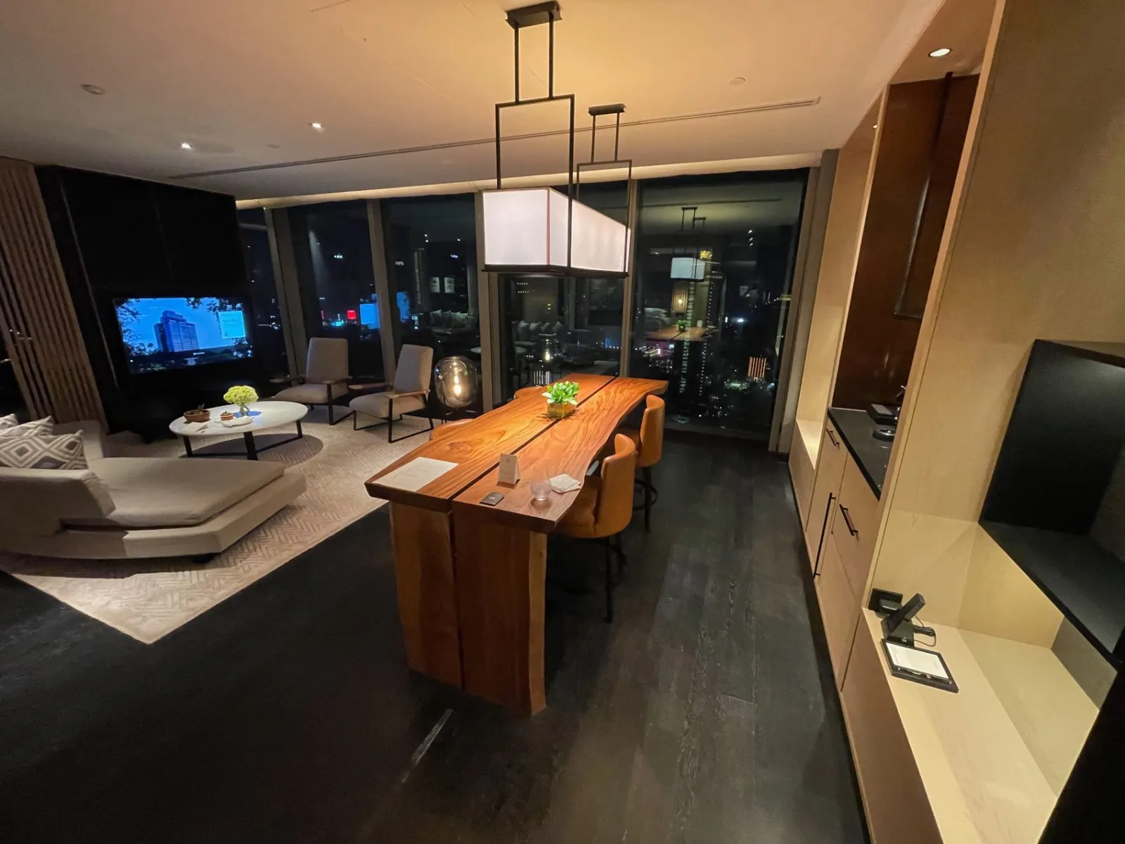 From my earlier stay: the Park Suite Deluxe King living and dining area, with its beautiful wooden table and nighttime city views.